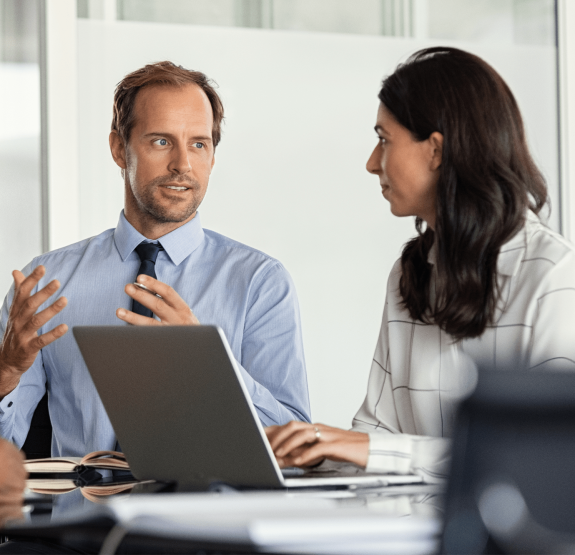 Man and woman on laptop talking